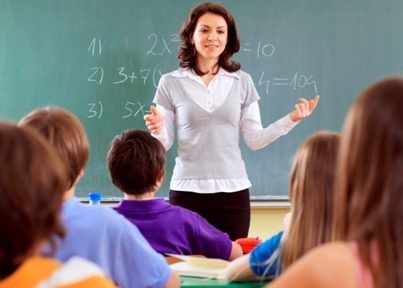 Teacher and student in a classroom at school.
